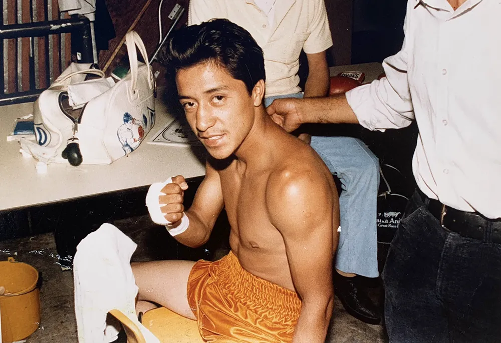 Carlos Manzano Jr. preparing for a fight with hand wraps